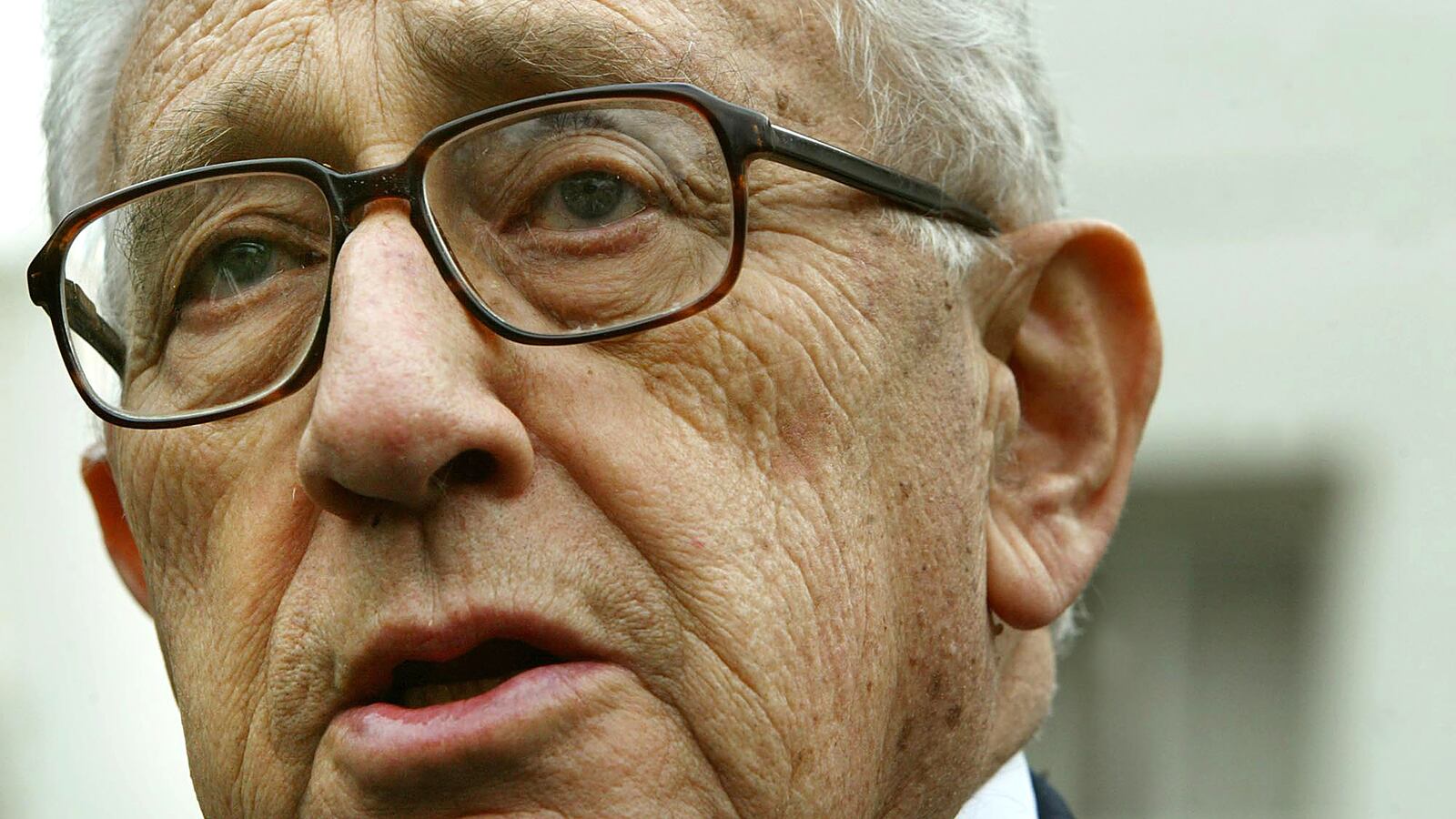 Former U.S. Secretary of State Henry Kissinger speaks to the news media after U.S. President George W. Bush named him to head a panel that will investigate the September 11 attacks, Nov. 27, 2002, at the White House.