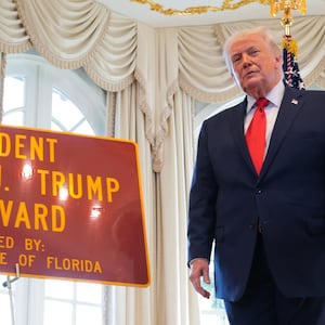 President Donald Trump poses for a photo with a sign that reads "President Donald J. Trump Boulevard" during a Road Dedication Ceremony at Mar-a-Lago on January 16, 2026 in Palm Beach, Florida. Florida State lawmakers approved the name change of a portion of Southern Boulevard to “President Donald J. Trump Boulevard.”