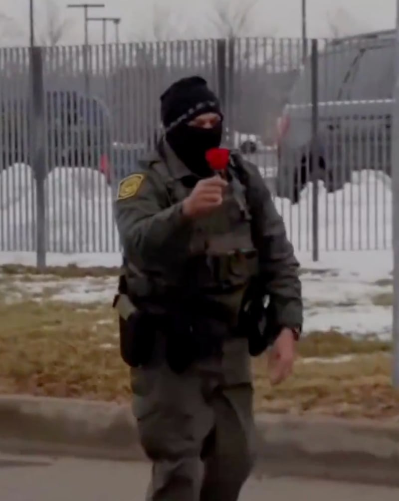 The agent shows off the rose to protesters.