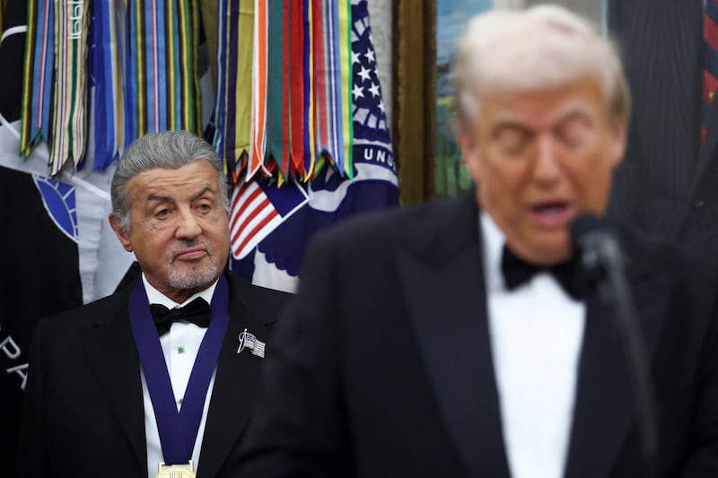 Kennedy Center Honors recipient actor Sylvester Stallone listens as U.S. President Donald Trump speaks during the Kennedy Center Honors medal presentation ahead of tomorrow's ceremony,  in the Oval Office of the White House in Washington, D.C.,  December 6, 2025.