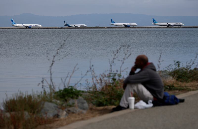 Planes line up on the runway to depart from San Francisco International Airport