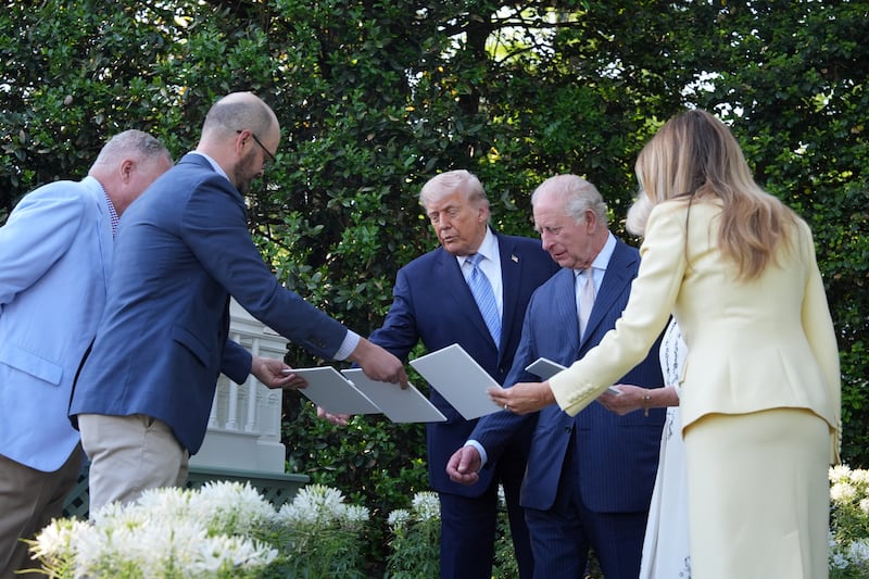 Donald Trump and Britain’s King Charles III look at the White House garden and beehive on the South Lawn of the White House.
