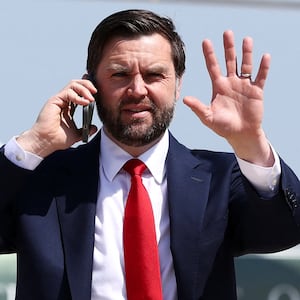 U.S. Vice President JD Vance talks on the phone on his way to  board  Air Force Two, as he departs for South Carolina to visit a steel factory, at Joint Base Andrews, Maryland, U.S., May 1, 2025.