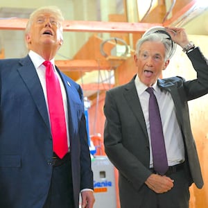 Donald Trump speaks with Federal Reserve chair Jerome Powell (R) as he visits the Federal Reserve in Washington, DC, on July 24, 2025.