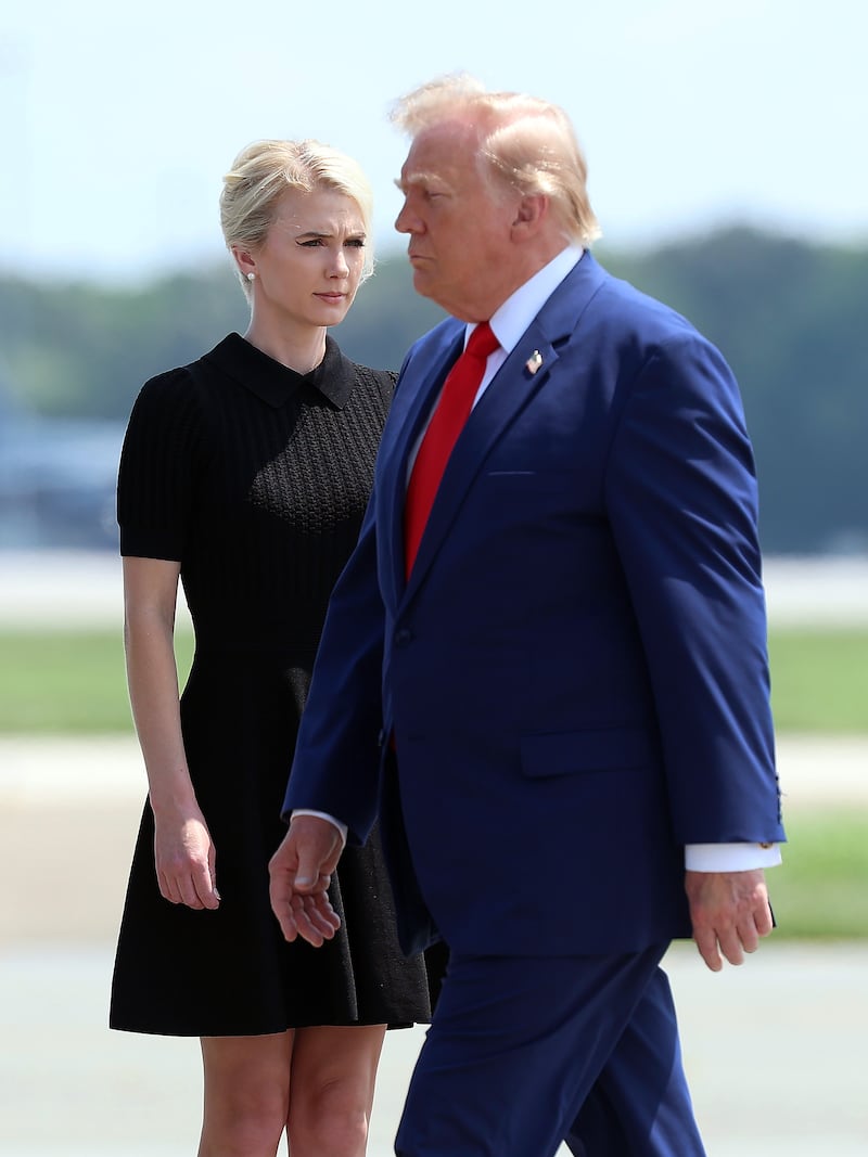 DOVER, DELAWARE - JULY 22: Natalie Harp, executive assistant to U.S. President Donald Trump, stands as President Trump arrives for a dignified transfer at Dover Air Force Base for military casualties of the war with Iran on July 22, 2026 in Dover, Delaware. Trump attend the dignified transfer of of Army 1st Lt. Tyler James Feehan, Staff Sgt. Michael Emmanuel Swinton, Army Sgt. Angel S. Rampersad and Army Pvt. Isabella Gonzales. (Photo by Kevin Dietsch/Getty Images)