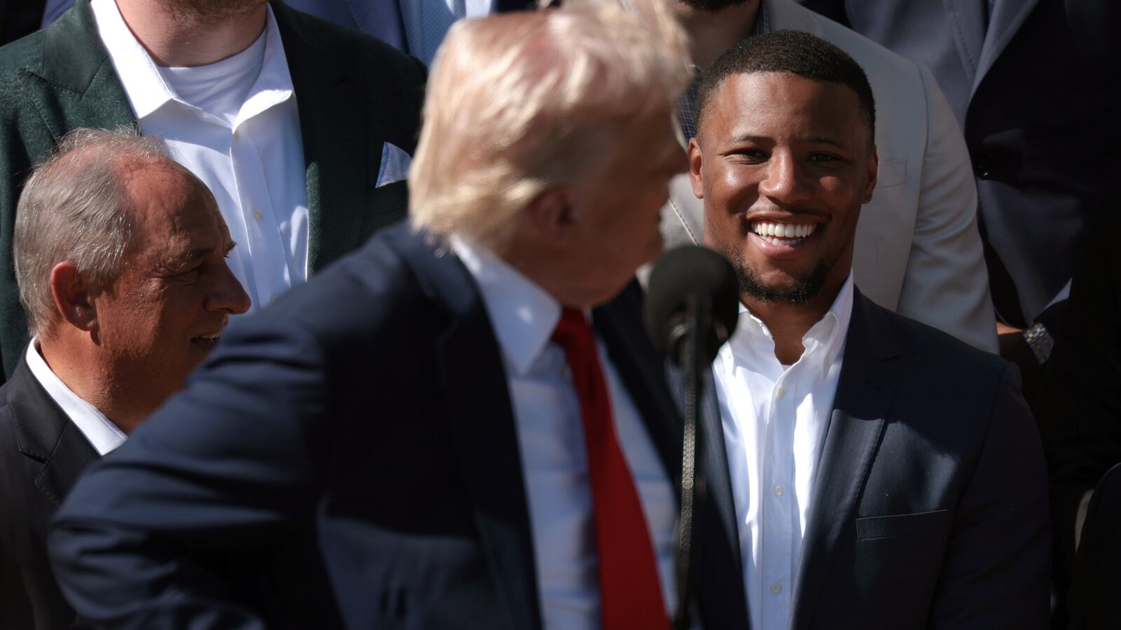 President Donald Trump turns to talk to Philadelphia Eagles running back Saquon Barkley