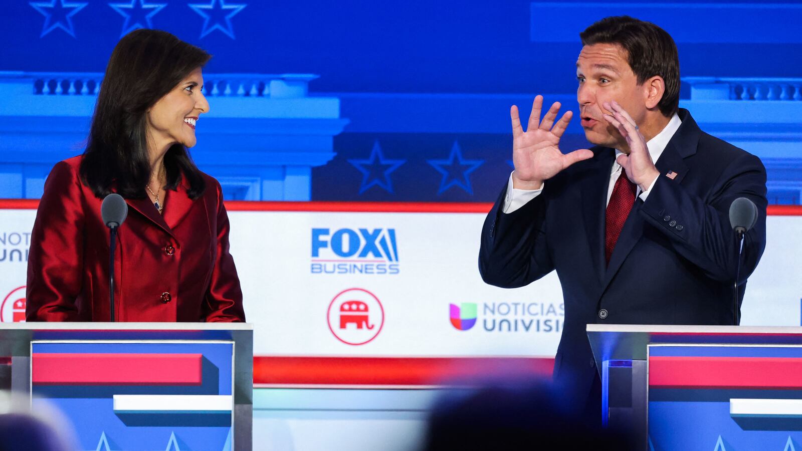 Florida Gov. Ron DeSantis and Nikki Haley debate on stage.