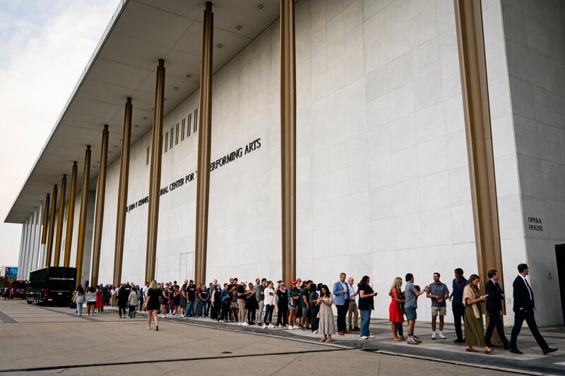 People wait in line prior to a prayer vigil for political activist Charlie Kirk outside the John F. Kennedy Center