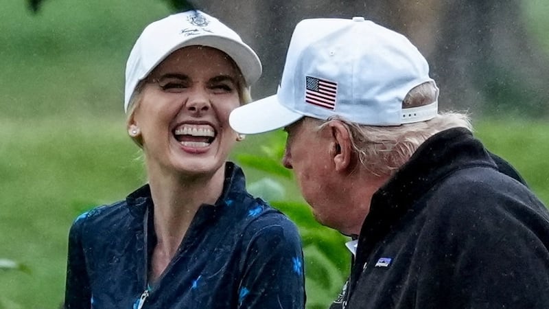 U.S. Interior Secretary Doug Burgum and Executive assistant to U.S. President Donald Trump Natalie Harp speak with Donald Trump during a visit at a golf course at Hains Point in Washington, D.C., U.S., June 28, 2026.