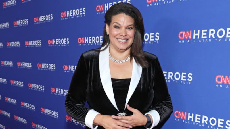 Sara Sidner smiles on a red carpet outside the CNN Heroes tribute.