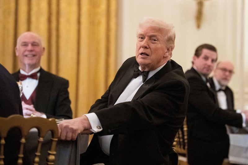 U.S. President Donald Trump and Governor of Montana Greg Gianforte watch a violin performance by Rusanda Panfili during a Governors Dinner at the White House in Washington, D.C., U.S., February 21, 2026. REUTERS/Aaron Schwartz    REFILE - QUALITY REPEAT AND ADDED IDS