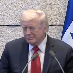 An aide tells Trump that it isn't his turn to speak.