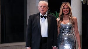 PALM BEACH, FLORIDA - DECEMBER 31: U.S. President Donald Trump and first lady Melania Trump arrive for a New Year’s Eve event at his Mar-a-Lago home on December 31, 2025 in Palm Beach, Florida. The president addressed guests and celebrated the arrival of 2026. (Photo by Joe Raedle/Getty Images)