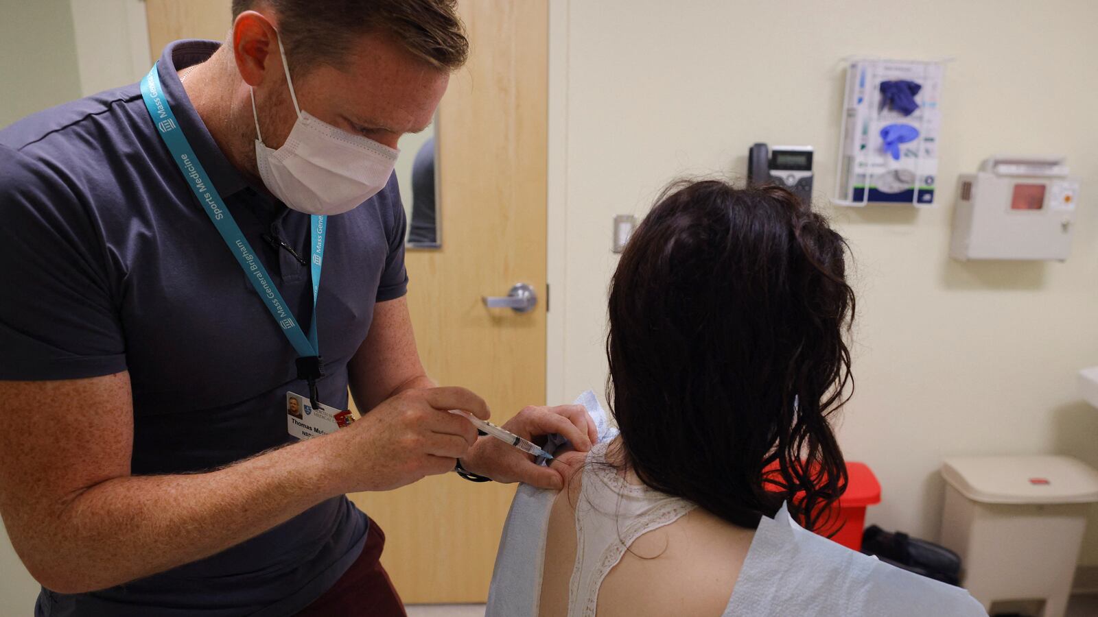 Kate Porter, who first was sick with COVID-19 in March 2020, receives a dry-needling treatment from Dr. Thomas Mulroy