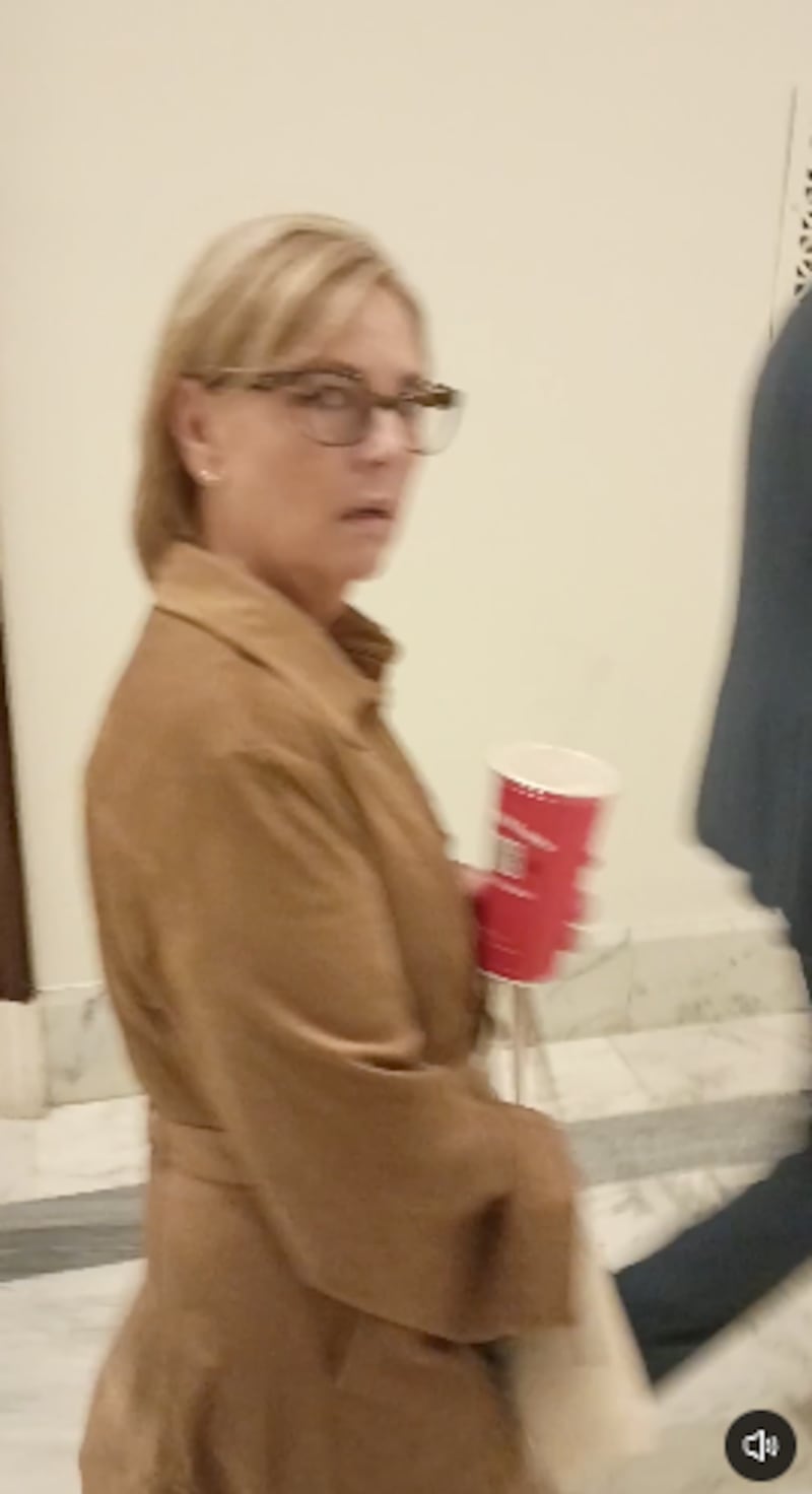 A woman in a camel look looking angry