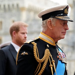 King Charles III (center) and Prince Harry follow the hearse with the coffin of Queen Elizabeth II moving towards St. George's Chapel at Windsor Castle, during the queen's funeral on September 19, 2022.