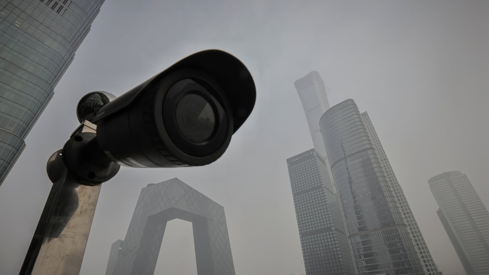 A surveillance camera points at a terrace of a shopping mall overlooking the skyline of the Central Business District on a polluted day in Beijing, China, November 5, 2021.