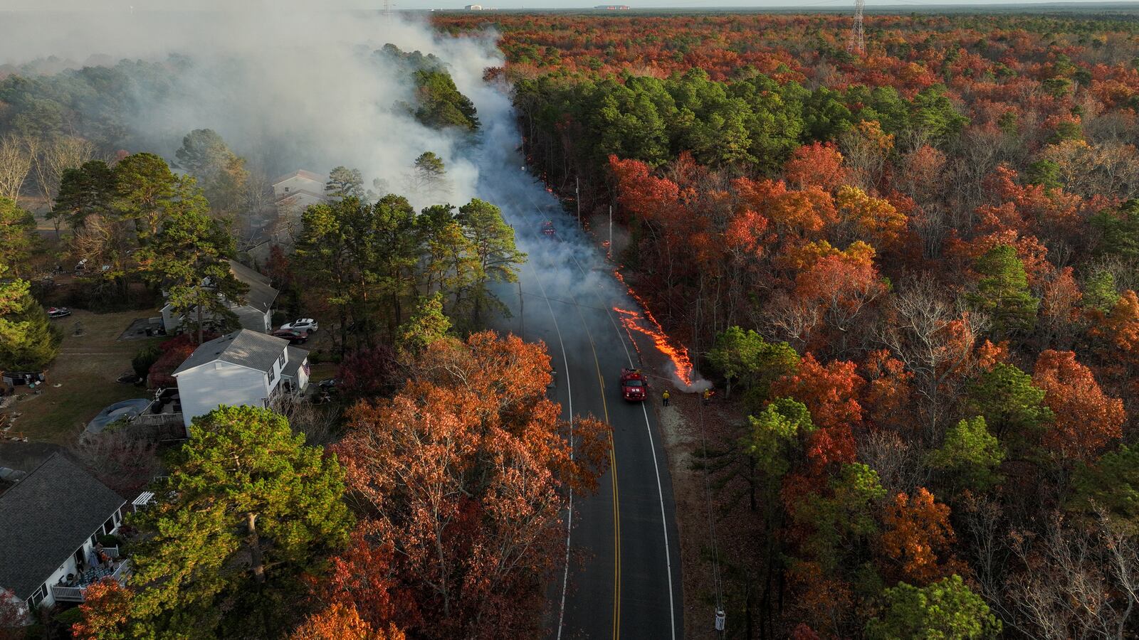 NEW JERSEY, US - NOV 5, 2024: Several homes were evacuated as a wildfire spread through the Colliers Mills Wildfire Management Area in Ocean County, New Jersey. The blaze, which threatens 25 structures, prompted an emergency response to safeguard nearby communities as firefighters worked to contain the flames amid dry, windy conditions. (Photo by Lokman Vural Elibol/Anadolu via Getty Images)