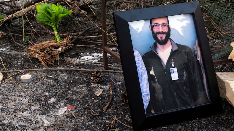 A photograph of 37-year-old Alex Pretti can be seen at a makeshift memorial in the area where he was shot dead by federal immigration agents earlier in the day in Minneapolis, Minnesota, on January 24, 2026.