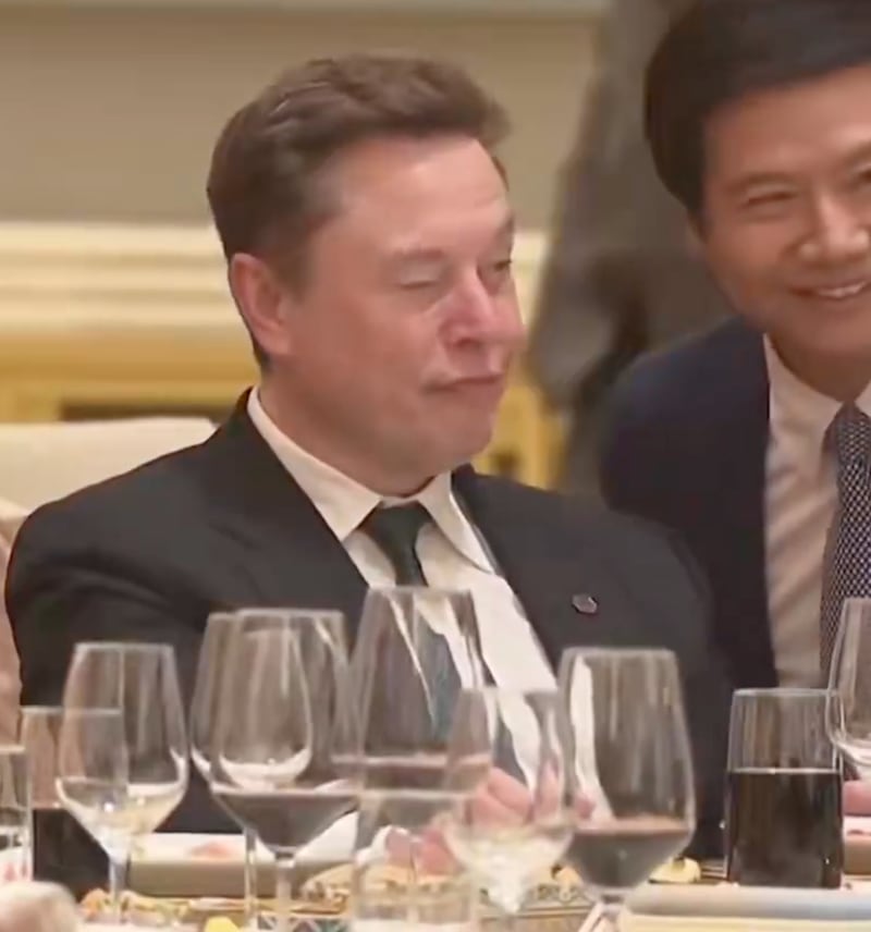 Musk taking a selfie with someone at the banquent.