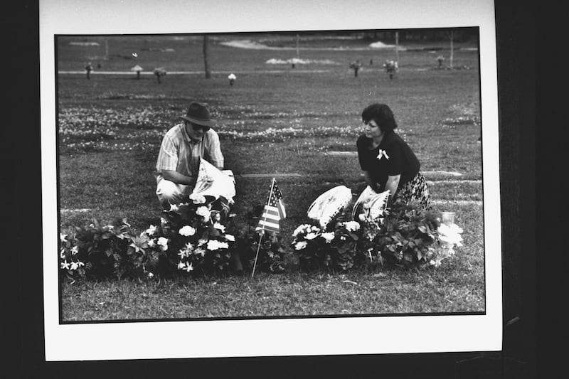 Barbara & Skip Suraci, the mother & stepfather of murder victims Jennifer & Sarah Harbison, visiting the flower-covered graves of their daughters who were shot to death at the end of their working shift at a yogurt shop.