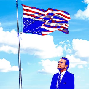 Pete Hegseth looks at an upside down American flag.