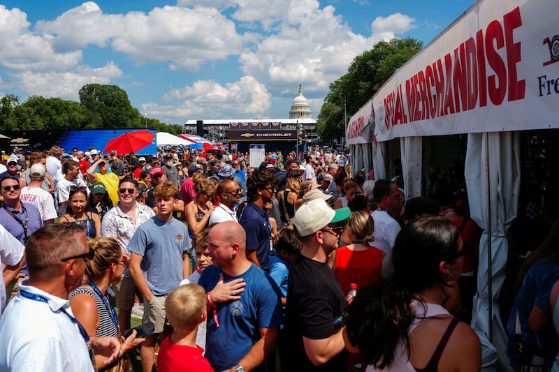 People queue for merchandise during the Freedom 250 Grand Prix IndyCar series race, with the U.S. Capitol seen in the background, in Washington, D.C., U.S., August 23, 2026. REUTERS/Aaron Schwartz