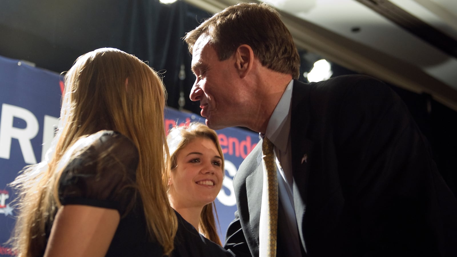 Mark Warner greets his daughters (L-R) Gillian and Madison at his victory party at the Hilton McLean Tysons Corner in McLean, Virginia.