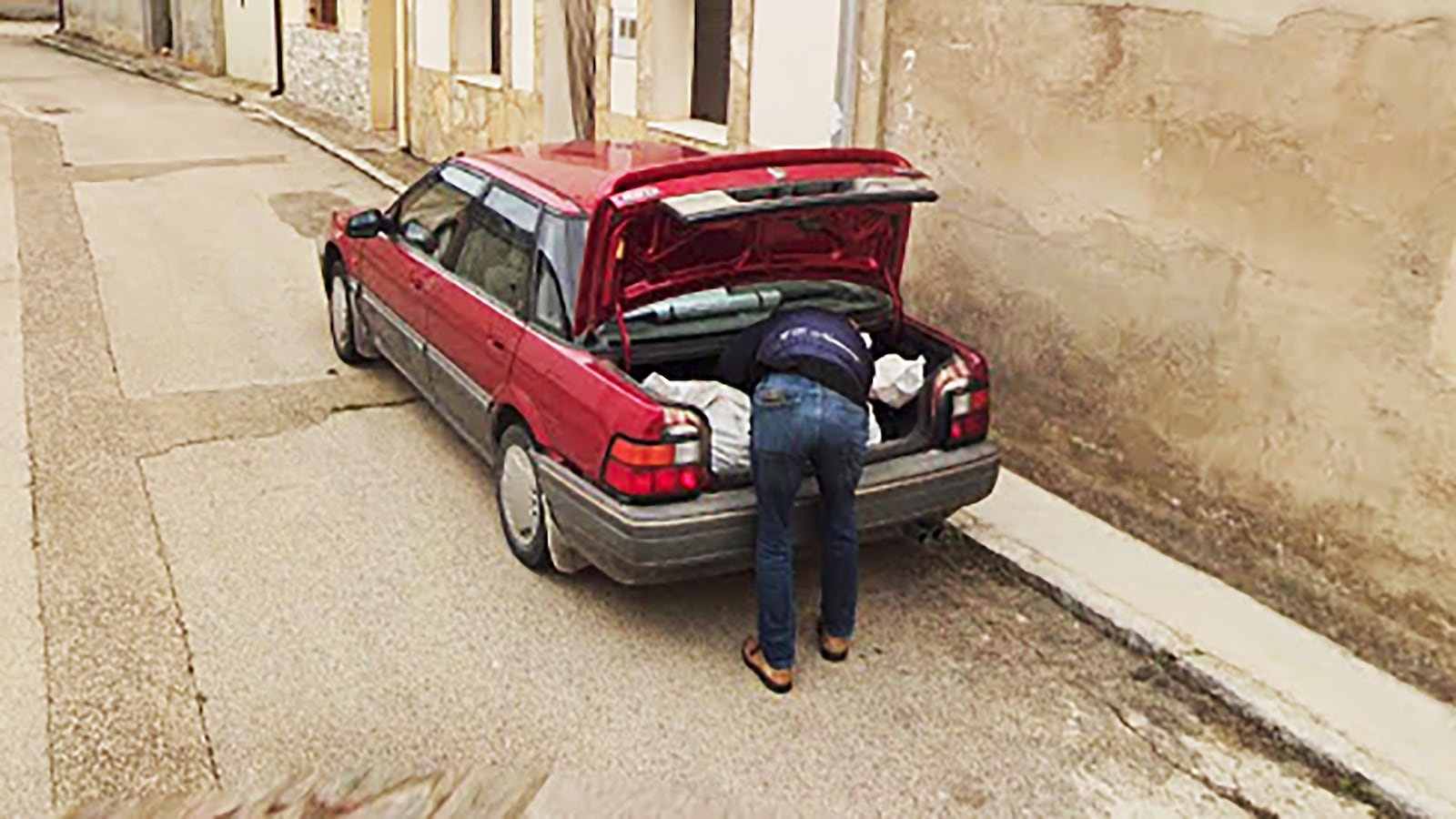 Man putting something in trunk