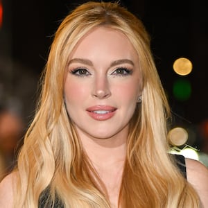 Lindsay Lohan, wearing her blonde hair in loose waves and a half-up hairstyle, attends the Our Little Secret screening at the Paris Theatre on November 18, 2024, in New York City.