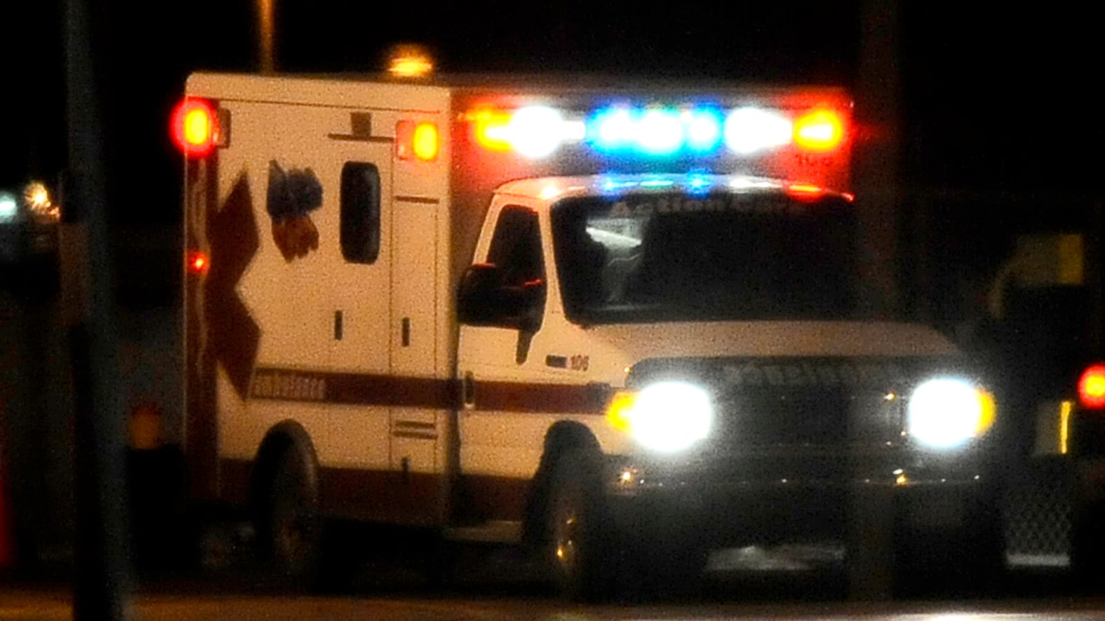 An ambulance drives at night