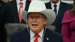 TOPSHOT - US President Donald Trump wears a cowboy hat during a bill signing ceremony with members of the 1980 US Olympic men's ice hockey team in the Oval Office of the White House in Washington, DC, on December 12, 2025. The legislation will award all of the players with Congressional Gold Medals to recognize the 45th anniversary of the US victory at the 1980 Winter Olympic Games. (Photo by Jim WATSON / AFP via Getty Images)