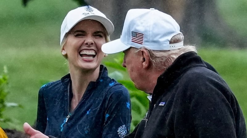 U.S. Interior Secretary Doug Burgum and Executive assistant to U.S. President Donald Trump Natalie Harp speak with Donald Trump during a visit at a golf course at Hains Point in Washington, D.C., U.S., June 28, 2026.