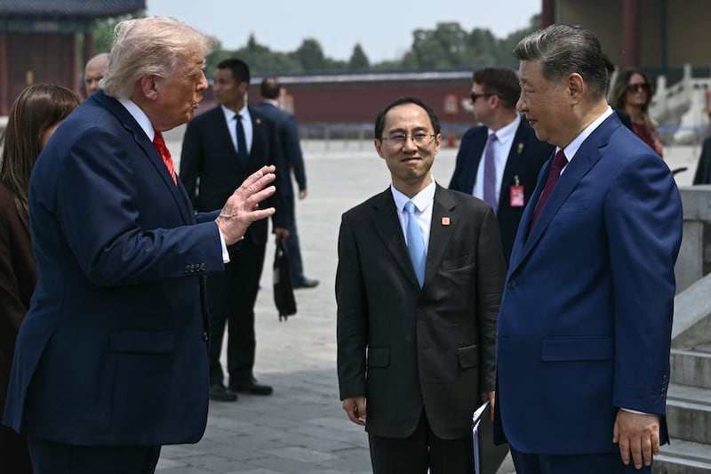 China's President Xi Jinping (R) and US President Donald Trump talk during their visit to the Temple of Heaven in Beijing on May 14, 2026. Xi warned Trump that the issue of Taiwan could push their two countries into "conflict" if mishandled, a stark opening salvo as a superpower summit set to tackle numerous thorny issues began in Beijing on May 14. (Photo by Brendan SMIALOWSKI / POOL / AFP via Getty Images)