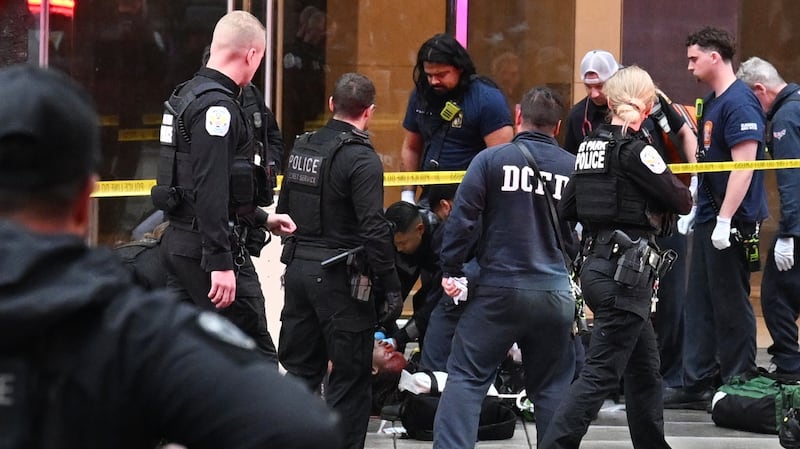 Members of the U.S. Secret Service tend to a wounded man on the scene of a shooting near the White House on May 23, 2026 in Washington, DC. Emergency teams work the scene after multiple rapid-fire gunshots ring out outside the White House.