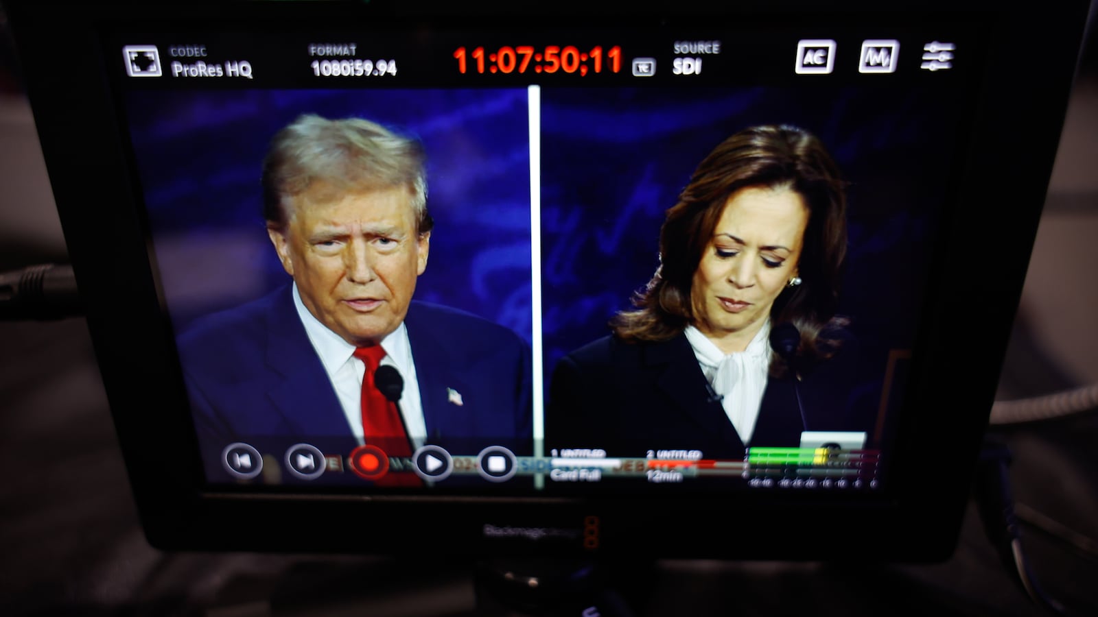 Donald Trump and Kamala Harris are seen on a screen as they debate for the first time during the presidential election.