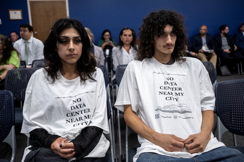 Daya Lopez and Jon Villegas attend a Harlingen City Commission meeting in regards to a data center being proposed by a subsidiary of Eneus Energy in Harlingen, Texas, U.S., May 6, 2026.