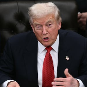 US President Donald Trump speaks while signing the bill package to re-open the federal government in the Oval Office of the White House in Washington, DC, on November 12, 2025.