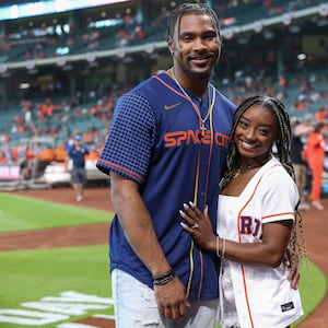 Simone Biles and Jonathan Owens pose for a picture before a game