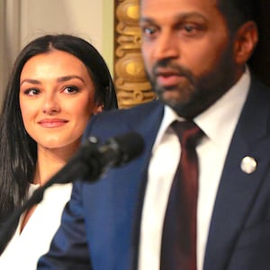 Kash Patel speaks as his girlfriend Alexis Wilkins (C) looks on during his swearing-in ceremony in the Indian Treaty Room in the Eisenhower Executive Office Building on February 21, 2025, in Washington, DC.