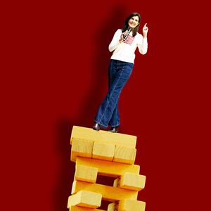 A photo illustration of Nikki Haley balancing on Jenga blocks.