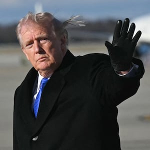 President Donald Trump waves after disembarking from Air Force One upon arrival at Joint Base Andrews in Maryland, March 23, 2026.