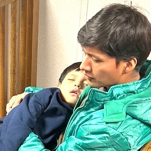 Liam Conejo Ramos lies unresponsive in his father's arms in ICE detention during the visit by Reps. Jasmine Crockett and Joaquin Castro.