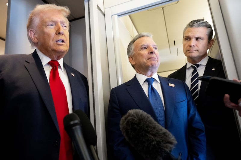 US President Donald Trump speaks with the media as Defense Secretary Pete Hegseth (R) and special envoy Steve Witkoff (C) look on aboard Air Force One during a flight from Dover, Delaware, to Miami, Florida, on March 7, 2026. (Photo by SAUL LOEB / AFP via Getty Images)