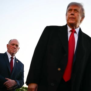 US President Donald Trump, flanked by White House 'border czar' Tom Homan (L) and US Secretary of Homeland Security Markwayne Mullin (R), speaks with workers who have been painting the Lincoln Memorial Reflecting Pool in Washington, DC, on May 7, 2026. Workers have been resurfacing the bottom of Washington's famous Lincoln Memorial Reflecting Pool with "American flag blue"-colored material used in swimming pools, following an order by US President Donald Trump. (Photo by Kent NISHIMURA / AFP via Getty Images)