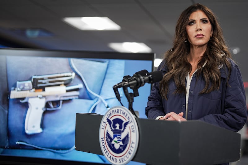 A photograph of the pistol recovered by immigration agents after a shooting in Minneapolis, Minnesota on Saturday morning is shown on a screen behind U.S. Secretary of Homeland Security Kristi Noem as she speaks during a news conference in the National Response Coordination Center at the Federal Emergency Management Agency (FEMA) headquarters on January 24, 2026 in Washington, DC.