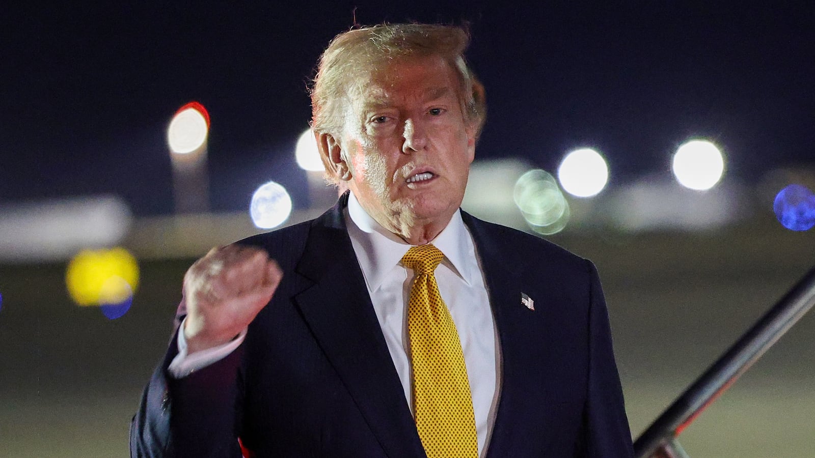 MILDENHALL, ENGLAND - JULY 08: U.S. President Donald Trump gestures as he steps off Air Force One to board the new Qatari-gifted Boeing plane, enroute to the United States following his participation in the NATO Summit at Royal Air Force Mildenhall on July 08, 2026 in Mildenhall, England. According to Trump, he departed the NATO Summit in Turkey onboard the previous Air Force One aircraft to allow U.S. service members stationed at RAF Mildenhall to tour the new Qatari-gifted Air Force One. (Photo by Win McNamee/Getty Images)