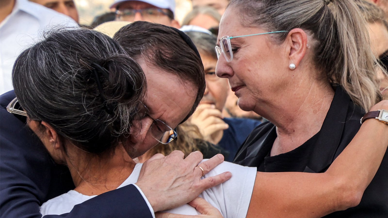 Israel's President Isaac Herzog and his wife Michal Herzog embrace Rachel Goldberg