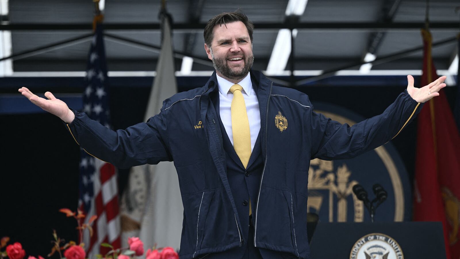 US Vice President JD Vance receives a Navy jacket as a gift after delivering the commencement address at the 2025 US Naval Academy graduation in Annapolis, Maryland, on May 23, 2025