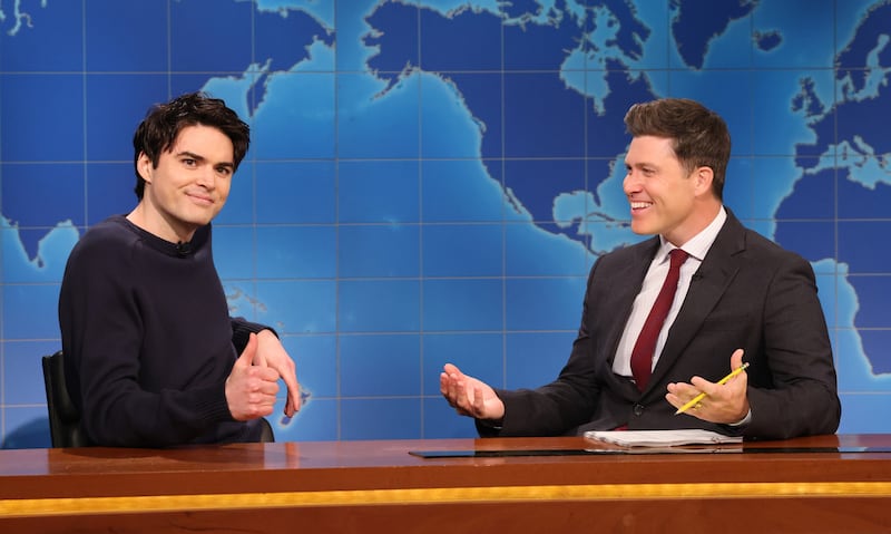 SATURDAY NIGHT LIVE -- Episode 1882 -- Pictured: (l-r) Michael Longfellow and anchor Colin Jost during Weekend Update on Saturday, May 3, 2025 -- (Photo by: Will Heath/NBC via Getty Images)
